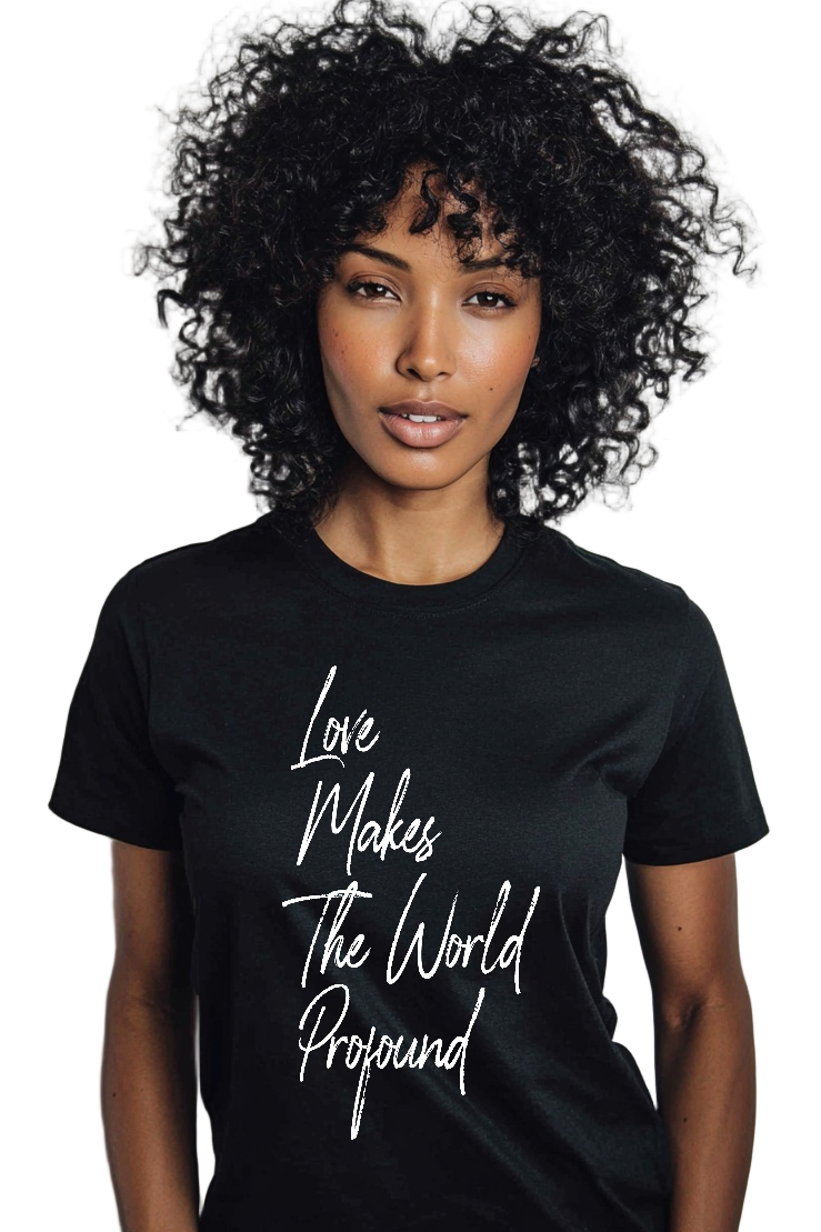 Person wearing a black t-shirt with 'Love Makes The World Profound' text on a plain background